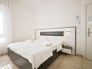 a bedroom with a large bed with white sheets at Estelle in Bari