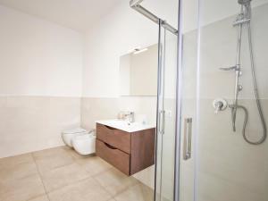 a bathroom with a toilet and a sink and a shower at Estelle in Bari
