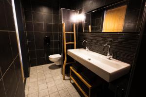 a bathroom with a sink and a toilet at Brouwersdam Stay in Ouddorp