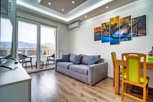 a living room with a couch and a table at Renome apartmani in Banja Koviljača