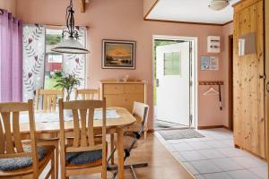 a kitchen and dining room with a table and chairs at BOH425-Henan-Tryckhalan-140 in Henån +15 photos