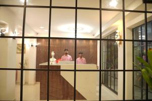 two people sitting at a table in a room at Hotel Flamount Hitech City in Hyderabad