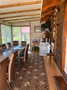 a dining room with a table and chairs and a kitchen at Pidkova in Verkhovyna