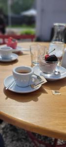 a cup of coffee and a bowl of fruit on a table at Apartmán Riverside Labe Vrchlabí in Vrchlabí