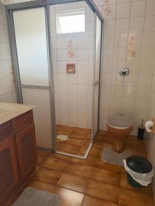 a bathroom with a shower and a toilet at Casa de temporada in Camboriú +1 photo