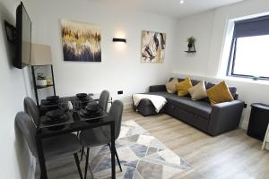 a living room with a couch and a table at Modern - City Centre - Free parking in Norwich