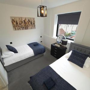 a bedroom with two beds and a window at Modern - City Centre - Free parking in Norwich