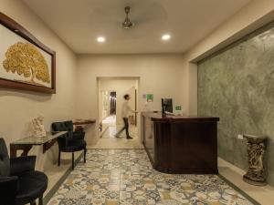 a person walking through a room with a lobby at Hotel Bernardino in Valladolid
