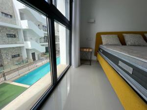 a bedroom with a bed and a large window at Sunny rest at Pedro's by PORT Holiday Rental in Arenales del Sol +25 photos