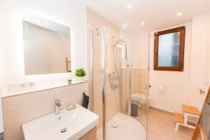 a white bathroom with a sink and a shower at Mosel-Refugium Nr 5 in Zell an der Mosel +20 photos