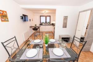 a dining room with two tables and a kitchen at Mosel-Refugium Nr 5 in Zell an der Mosel