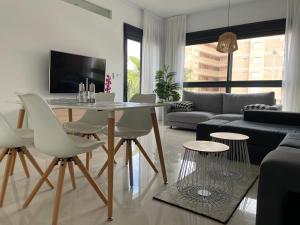 a living room with a table and chairs and a couch at Sunny rest at Pedro's by PORT Holiday Rental in Arenales del Sol