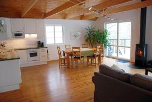a kitchen and living room with a table and chairs at JON404-Skillingaryd-Galtas in Skillingaryd