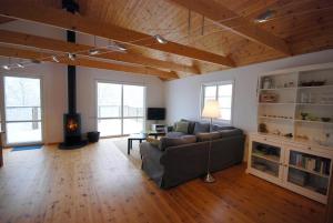 a living room with a couch and a fireplace at JON404-Skillingaryd-Galtas in Skillingaryd