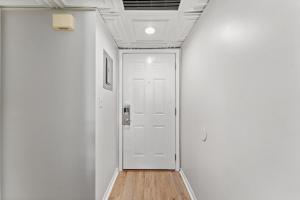a hallway with white walls and a white door at Beachfront Condo With Beautiful Sunset in Panama City Beach +27 photos