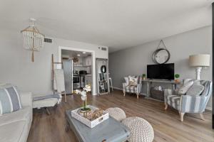 a living room with a couch and a table at Beachfront Condo With Beautiful Sunset in Panama City Beach