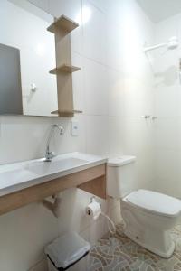 a white bathroom with a sink and a toilet at Casa de Gil do Pão in Lençóis +19 photos