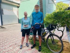 a man and a woman standing next to a bike at Thisu Villa in Dickwella