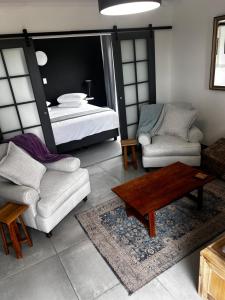 a living room with a bed and a table at 122 Shearwater - Nora's Place in Sedgefield +63 photos
