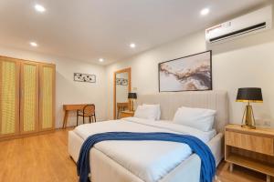 a bedroom with a large white bed in a room at Aima Apartments in Lagos
