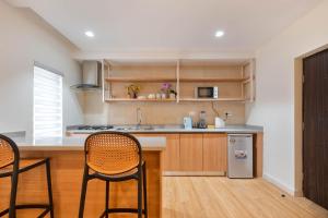 a kitchen with two chairs and a counter top at Aima Apartments in Lagos