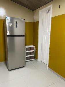 a kitchen with a refrigerator in a room at Casa do Sal in São Luís