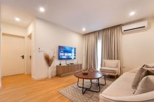 a living room with a couch and a table at Aima Apartments in Lagos +4 photos