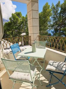 a table and two chairs on a balcony at Inas Place in Baška Voda