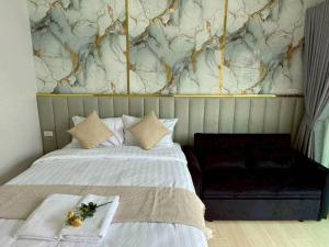 a bedroom with a bed with a marble wall at NY grand villa in Nong Prue +32 photos