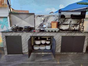 a kitchen with a counter with a stove at NY grand villa in Nong Prue