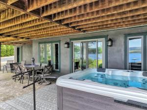 a hot tub in a room with a table and chairs at Lakefront Sunsets, Hot Tub, Pool Table, Kayaks in Lake Ariel