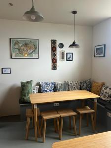 a table in a living room with a couch at Skyrhusid Guesthouse in Hali +82 photos