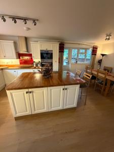 a kitchen with a large island in the middle at Hillhouse in Hythe