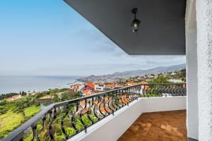 a balcony with a view of the ocean at Villa Amor Do Mar -180° Sea View, Jacuzzi,Terrace in Funchal
