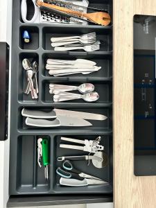 a drawer filled with lots of kitchen utensils at La Belle Cachette in Matougues