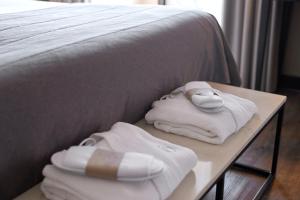 a bed with white towels and a mouse on a table at Van der Valk Hotel Saint-Aygulf in Saint-Aygulf