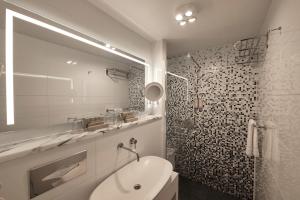 a bathroom with a toilet and a sink and a shower at Van der Valk Hotel Saint-Aygulf in Saint-Aygulf