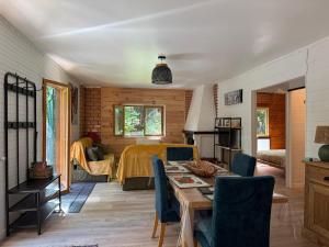 a living room with a table and a bedroom at Lou Rigal in Dourbies