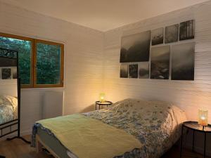 a bedroom with a bed and two tables with lamps at Lou Rigal in Dourbies