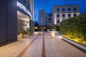 a walkway in front of a building at night at LVG Hotel Collection - Gardenia in Verona