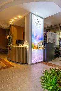 a lobby with a large screen in a building at LVG Hotel Collection - Gardenia in Verona