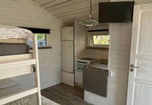 a small kitchen in a tiny house at HAL908-Skummesloevsstrand-Rundan-37 in Skummeslövsstrand