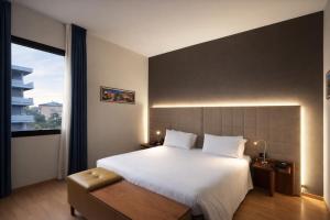a bedroom with a large white bed and a window at LVG Hotel Collection - Gardenia in Verona +62 photos