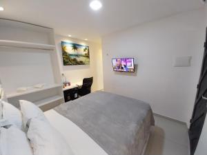 a bedroom with a bed and a desk in it at Pousada Dunas Natal in Natal +51 photos