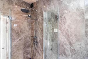 a shower with a glass door in a bathroom at HAL901-Skummesloevsstrand-Rundan-37 in Skummeslövsstrand +24 photos