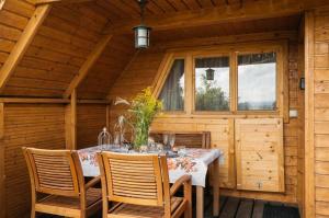 a wooden dining room with a table in a cabin at Mała Toskania in Kawec