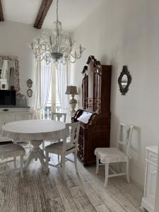 a dining room with a table and chairs and a chandelier at Maison Menton in Menton +19 photos