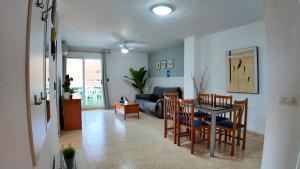 a living room with a table and chairs and a couch at Apartalux Magic Paradise in Oropesa del Mar +60 photos