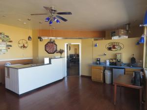 a kitchen with a counter and a ceiling fan at Economy Inn in Socorro