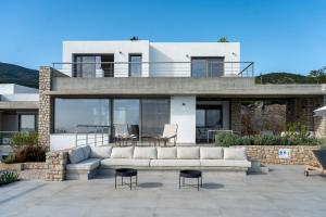 a house with a couch on a patio at Villa Rosemary in Xiropigado